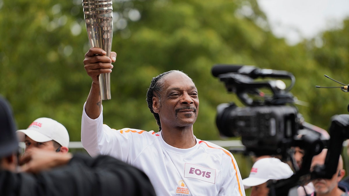 Snoop Dogg celebrates with US swimmer’s wife during gold medal race in heartwarming moment